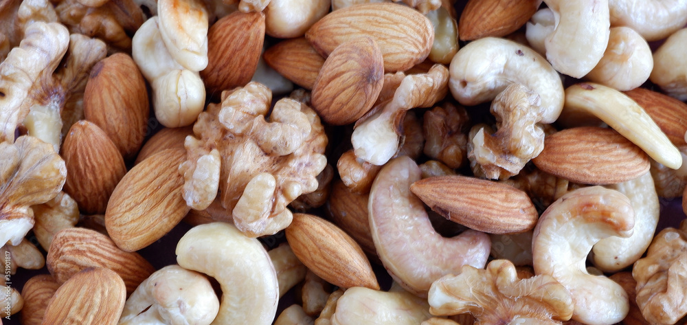 Set of nuts: almonds, cashews, walnuts. The texture of the nuts. Suitable for backgrounds.