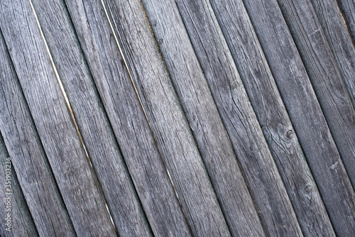 The texture of the boards. Brown painted fence.