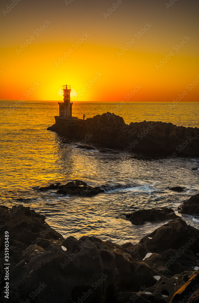 The Lighthouse with beautiful light in the town of Pasajes San Juan near San Sebastian. Gipuzkoa, Basque Country. Vertical photo