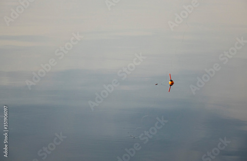 Fishing float on the water. Fishing with a float rod on the water