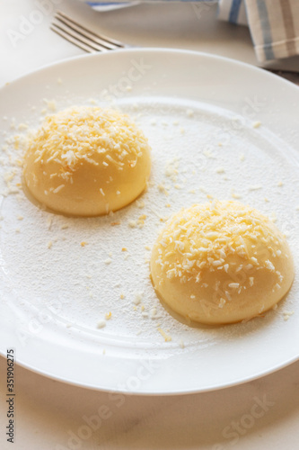 Cream pudding with vanilla on a white plate.