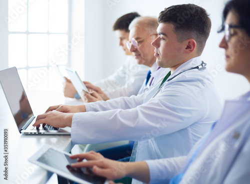 Medical team sitting and discussing at table