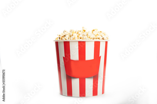 Paper cup with popcorn isolated on a white background.
