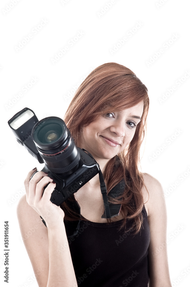Smiling young girl holding camera, isolated on white background Smiling young girl holding camera, isolated on white background