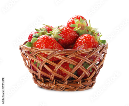 Ripe strawberries in wicker bowl isolated on white