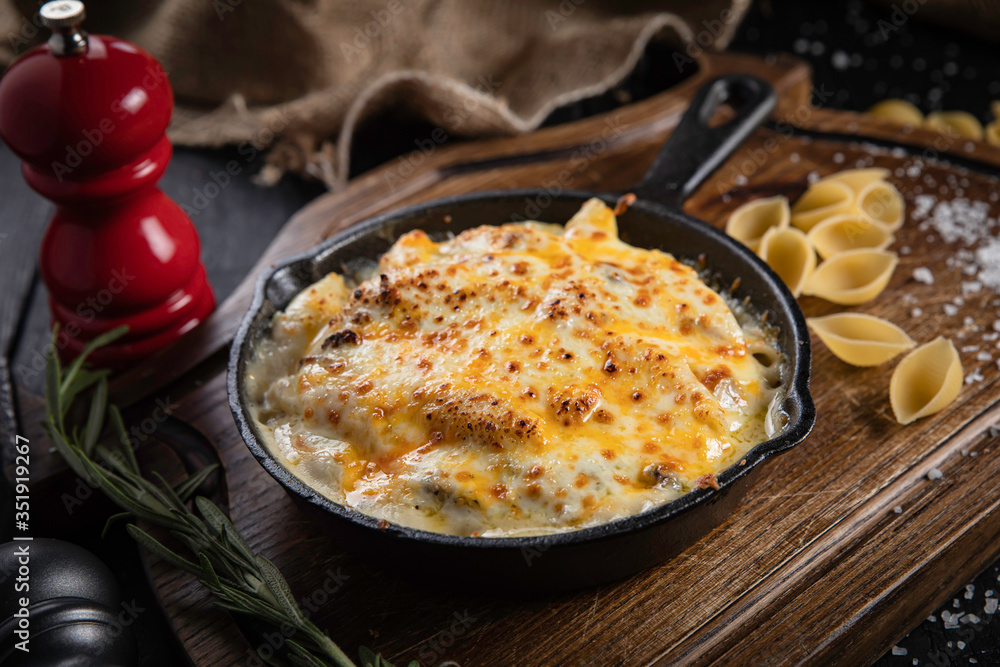 Pasta with cheese and chicken on a black background Pasta with cheese and chicken on a black background