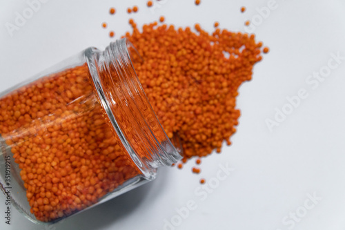 Red lentils isolated on white background. Top view.