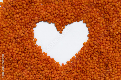Red lentils isolated on white background. Top view.