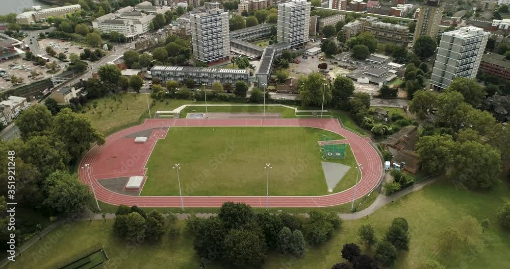 Athletics track in the heart of a city with high rise flats Athletics track in the heart of a city with high rise flats