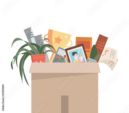 box with personal belongings.  dismissal from work.  fall under job cuts.  box with books, papers, photography, plants, awards.