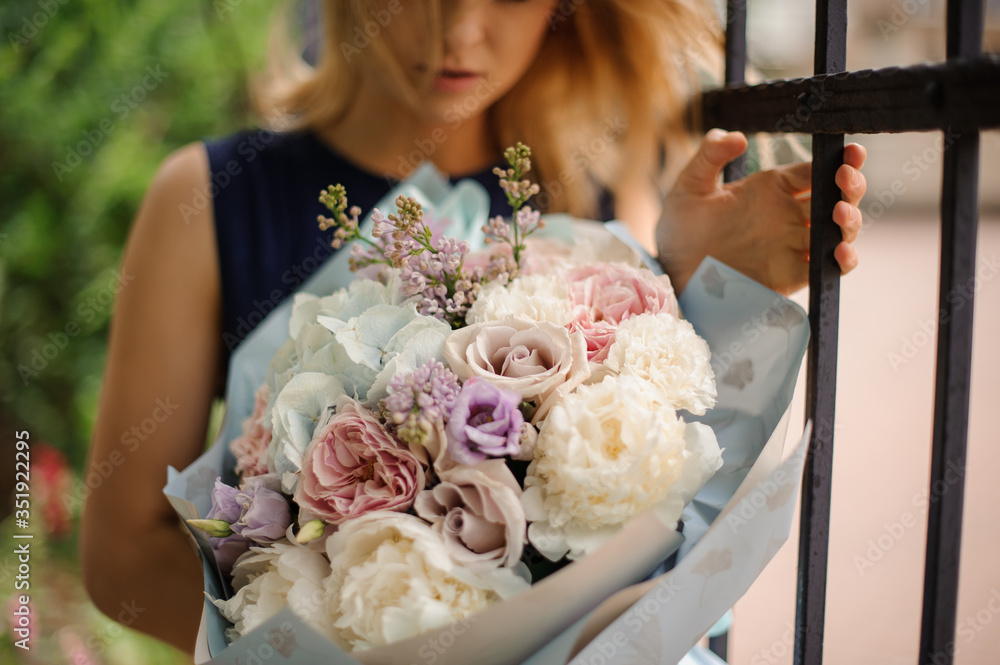 Close-up of bouquet in pastel colors in the hands of girl. Close-up of bouquet in pastel colors in the hands of girl.