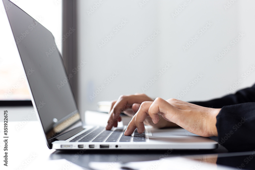 Financial businessmen use laptop to analyze marketing strategies and real estate data to reduce company taxes for their customers, Accounting and Tax concept. Financial businessmen use laptop to analyze marketing strategies and real estate data to reduce company taxes for their customers, Accounting and Tax concept.