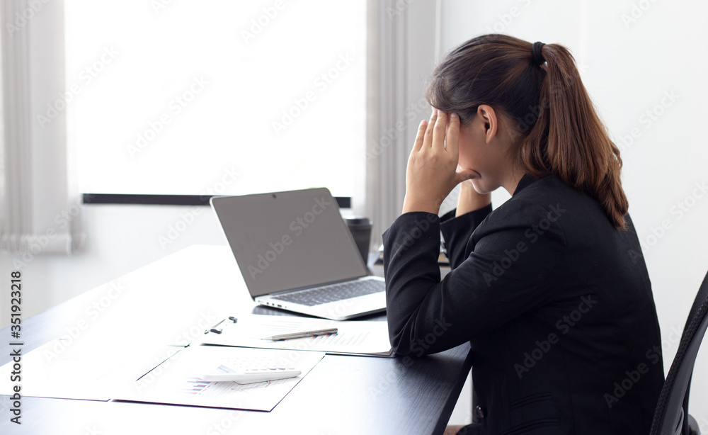She is stressed due to the economic downturn causing migraine headaches, Financial accountants work on the analysis and summary of company revenue in real estate, Hard work and overtime work concept. She is stressed due to the economic downturn causing migraine headaches, Financial accountants work on the analysis and summary of company revenue in real estate, Hard work and overtime work concept.