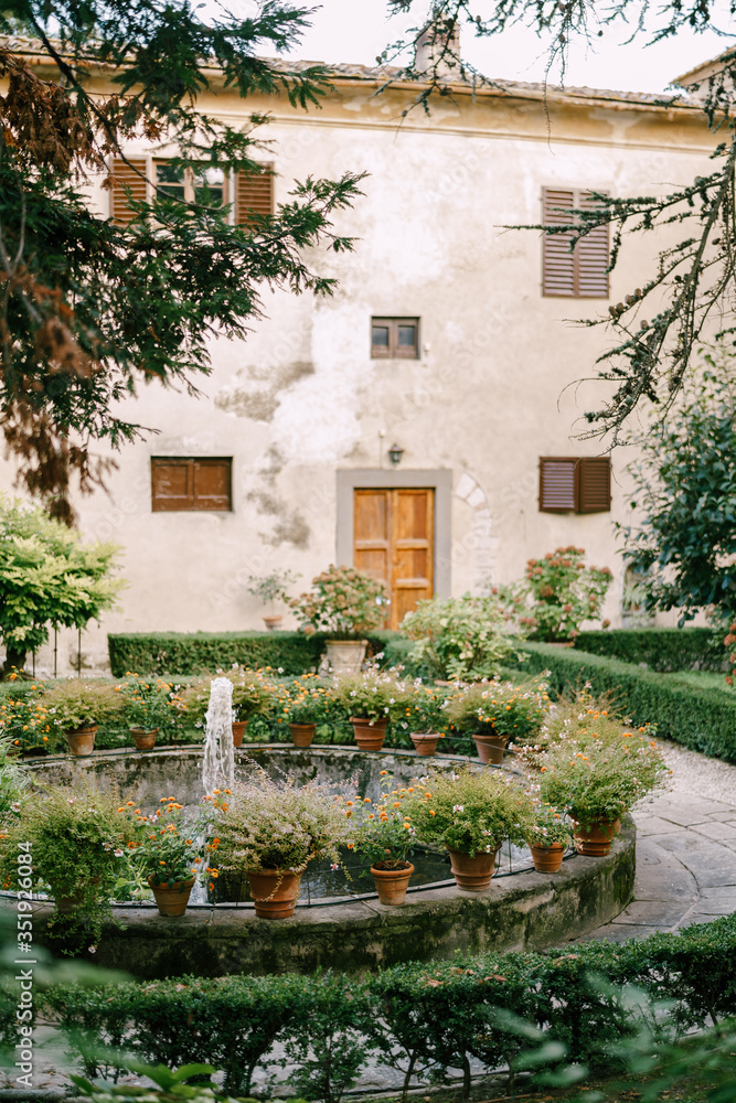 An ancient fountain in the centre of the courtyard of a winery in Italy, Tuscany.