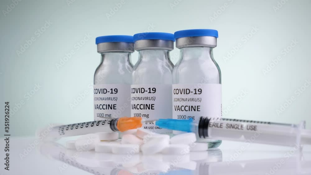 Medical syringes, pills and vials of vaccine against Covid-19 rotate on a white background. Close-up on a white surface. Concept of Coronavirus vaccination people. Pharmacology industry. Medical syringes, pills and vials of vaccine against Covid-19 rotate on a white background. Close-up on a white surface. Concept of Coronavirus vaccination people. Pharmacology industry.