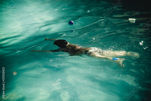 child swims in the pool © Marina