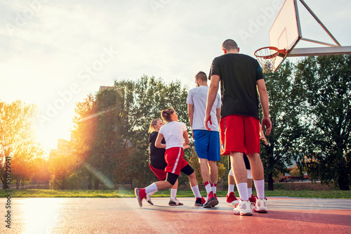 Group Of Young Friends Playing Basketball Match