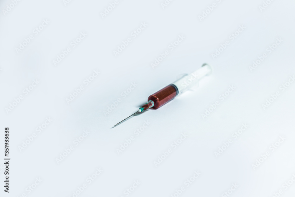 Fototapeta premium Syringe with blood on white background.