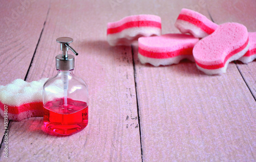 refresh and disinfection the house , tools for cleaning home , pink sponges and crystal dispenser with red liquid