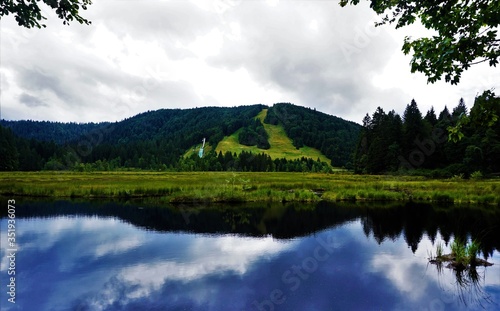 Blue sky reflecting in Lispach lake near La Bresse