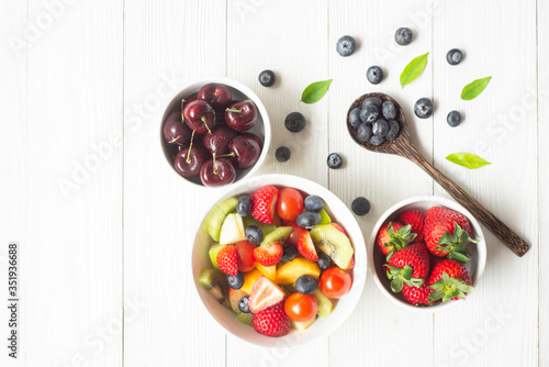 Fototapeta Naklejka Na Ścianę i Meble -  Healthy foods  Concept ,blueberry  strawberry apple  with salad  in  bowl on white wood background