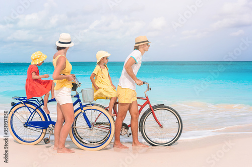 Family with a bike on tropical beach