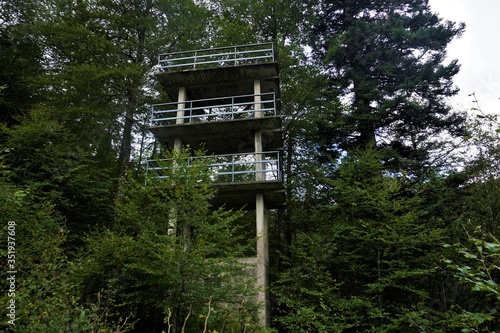Ruin of a tower made of concrete with guardrail spotted in the forest in the Vosges