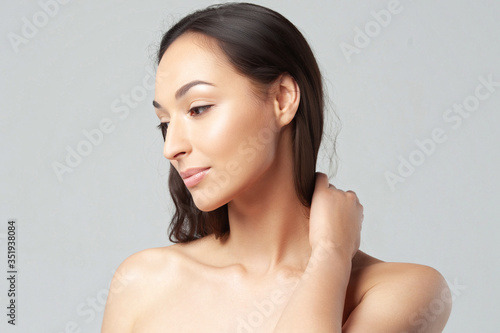 Portrait of young beautiful woman with clean perfect skin