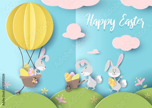 Happy easter greeting card in paper art style vector illustration. Banner with cute rabbits holding eggs on sunny meadow flat design. Spring holiday concept