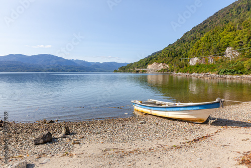 Boat anchored on the beach of the fjord of Puyuhuapi, Patagonia, Chile. Pacific Ocean photo