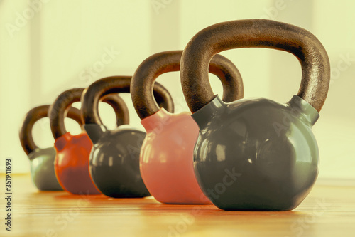 Fototapeta Naklejka Na Ścianę i Meble -  Colorful kettlebells in gym