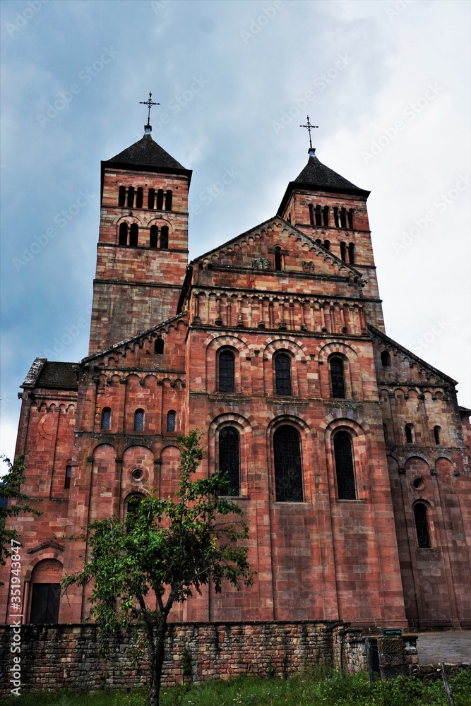 Murbach abbey looks gigantic next to the tree next to it