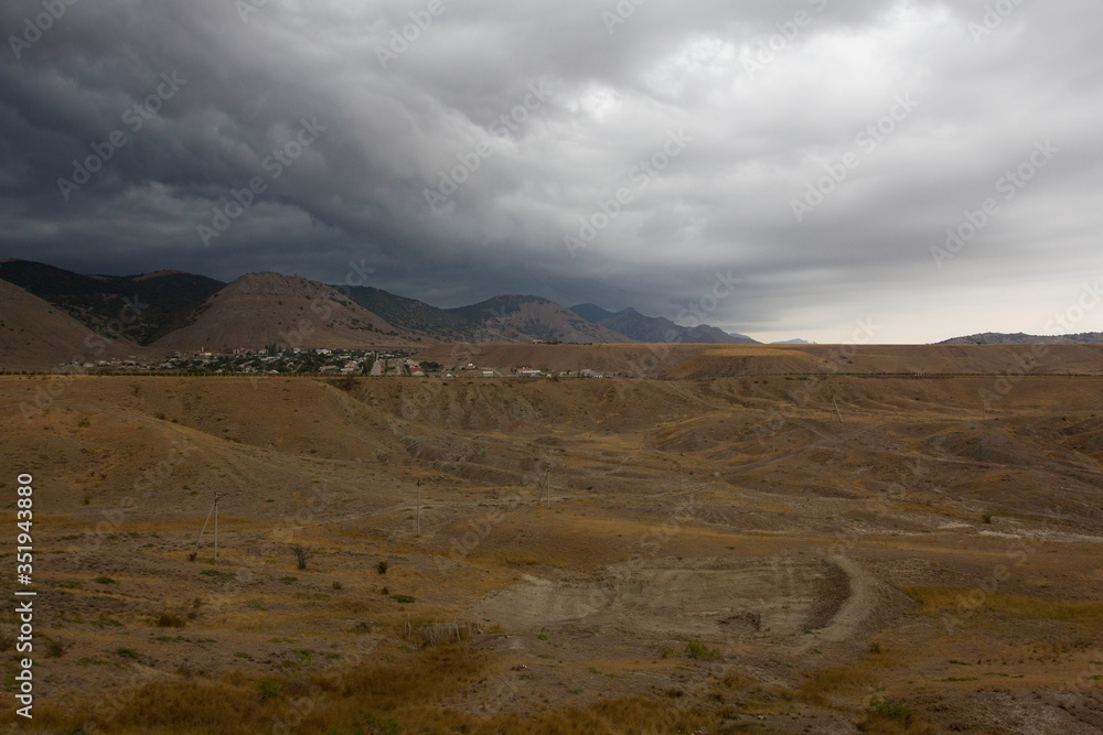 View of the rain clouds over the mountains. Gathering storm, dramatic scene. Sun Valley, Crimea.
