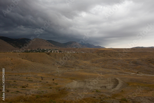View of the rain clouds over the mountains. Gathering storm  dramatic scene. Sun Valley  Crimea.