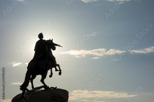 Silhouette of an equestrian monument against a bright sky