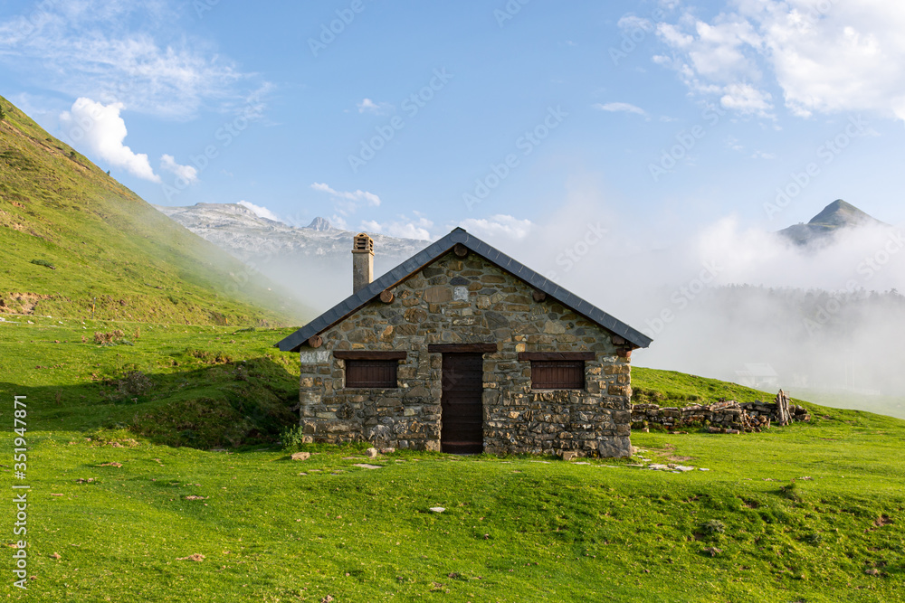 Mountain shelter with a chimney in Pirineos in a foggy day Mountain shelter with a chimney in Pirineos in a foggy day