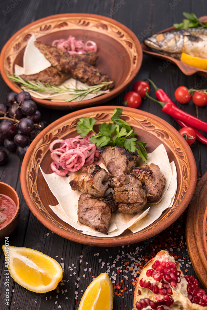 Grilled meat on pita with pickled onions and herbs