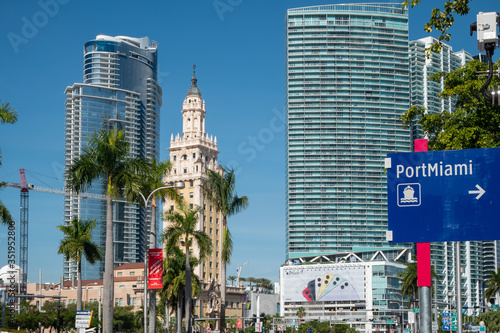 Historic Freedom Tower nestled between modern high-rise buildings in Miami, Florida. photo