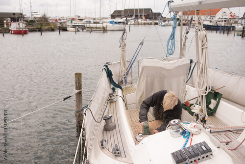 Senior man fixing up his boat 
