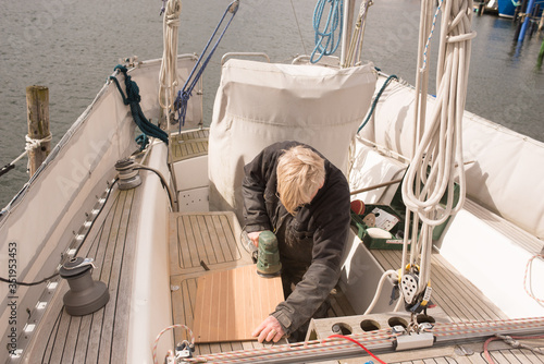 Senior man fixing up his boat 