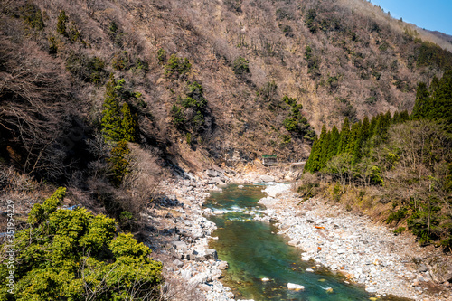 Japan rural countryside area in Gifu prefecture, Hida with Miyagawa river green colorful water in mountains during spring high angle view