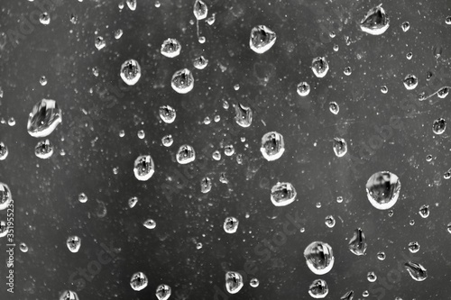 drops of water on window black and white 