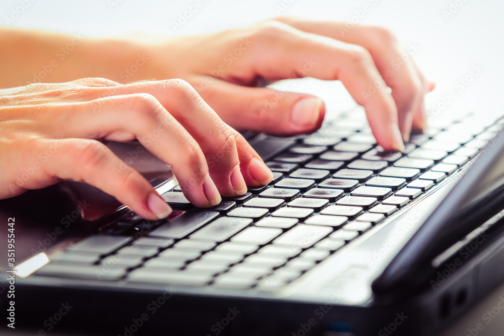 Close up of female hands working on a laptop. Close up of female hands working on a laptop.