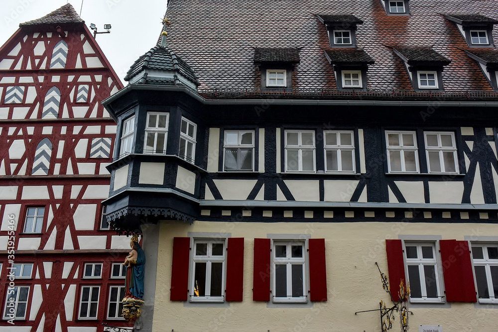 Traditional half-timbered houses on narrow medieval street in Rothenburg ob der Tauber, Bavaria, Germany. November 2014 Traditional half-timbered houses on narrow medieval street in Rothenburg ob der Tauber, Bavaria, Germany. November 2014