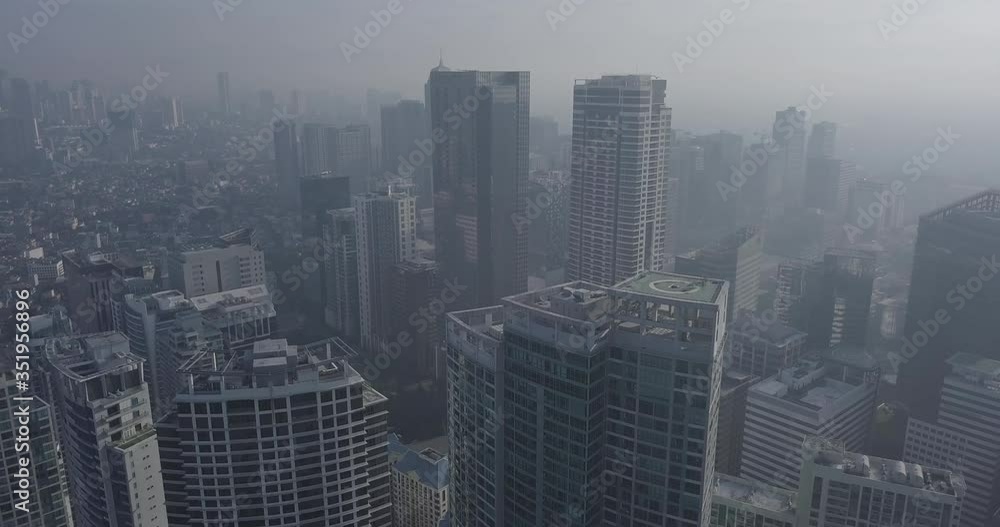 Ungraded, Ascending aerial flight through business district revealing metropolitan city's skyline. Drone, 4K. Ungraded, Ascending aerial flight through business district revealing metropolitan city's skyline. Drone, 4K.