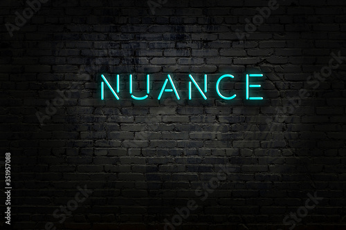 Neon sign with inscription nuance against brick wall