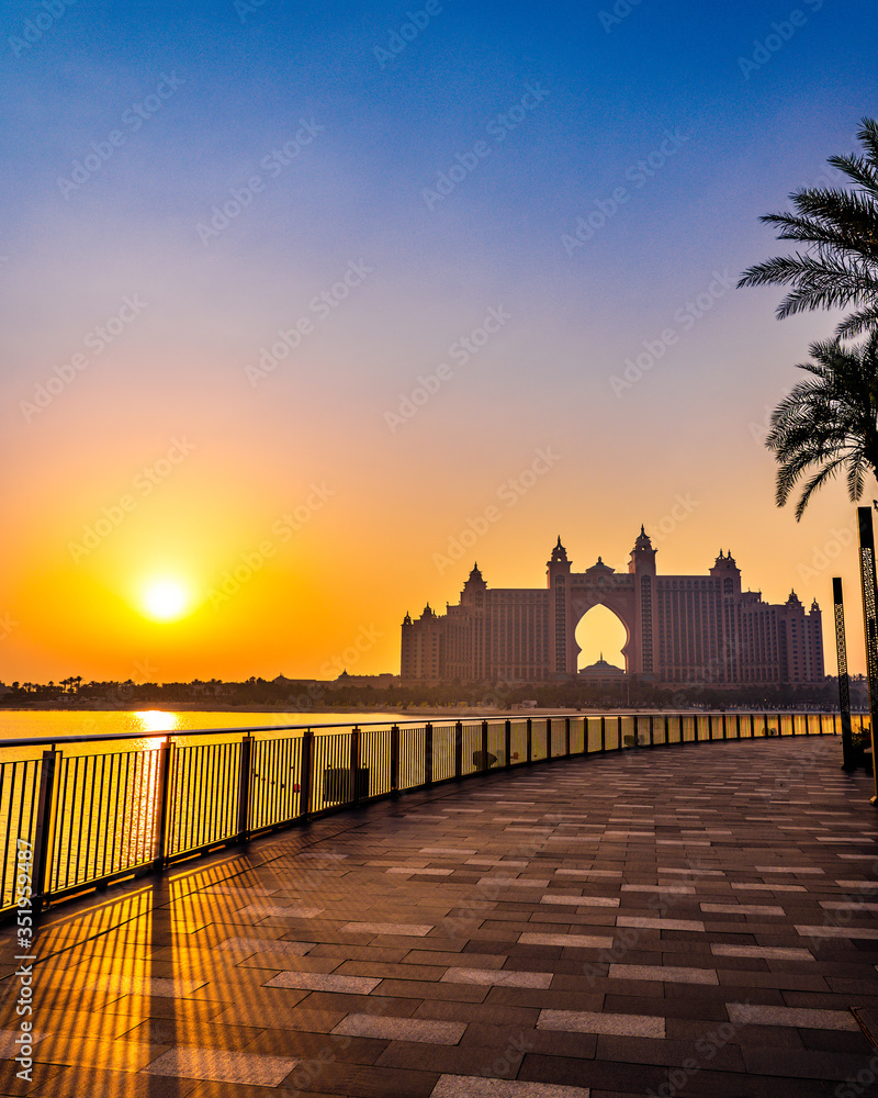 DUBAI / UNITED ARAB EMIRATES - MAY 2020: The multi-million dollar Atlantis resort in Palm Jumeirah during golden hour. The beautiful Atlantis hotel with a fiery orange sky in the background. 