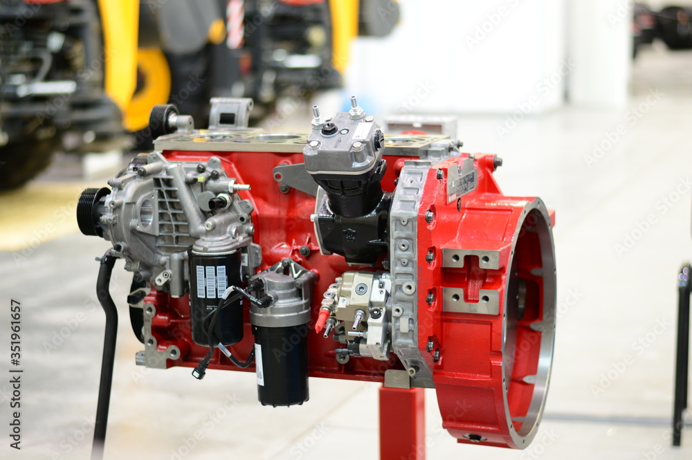 Red disassembled tractor engine stands Red disassembled tractor engine stands