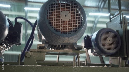 Small electric motor on a woodworking machine. Belting. Slowmotion shot in 4k.