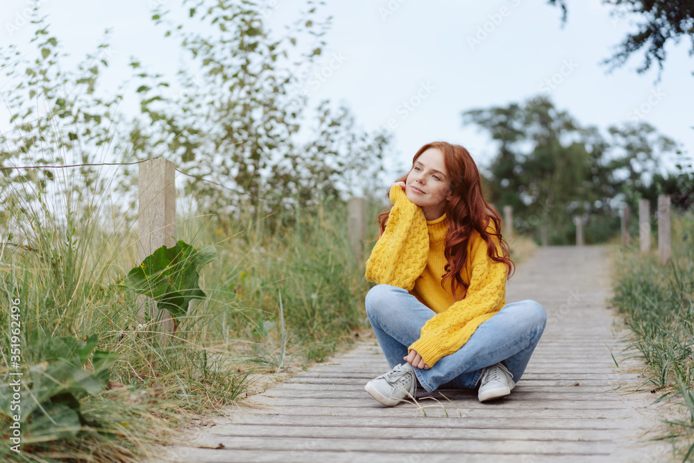 Thoughtful young woman relaxing in nature Thoughtful young woman relaxing in nature